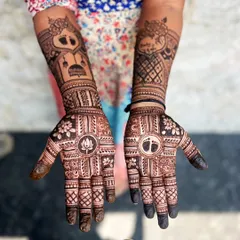 This custom baby shower design features a traditional cradle on one forearm and a lotus on the palm. The other hand has a baby footprint in the center of the palm, making it a very personal and meaningful design for the mom to be.