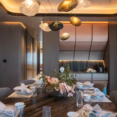 In this dining space, sophistication and functionality blend seamlessly. The centerpiece, a bespoke dining table with a unique veined marble top, is paired with elegant chairs from Giorgetti and Baxter, creating a perfect balance of comfort and aesthetics.