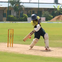 A moment of pure focus during batting practice. We emphasize strong fundamentals and technique, ensuring every player hones their skills through dedicated, hands-on coaching sessions.