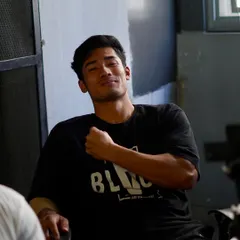 The deck where champions are made. A member relaxes and smiles after a tough session, feeling the positive vibe of our community.