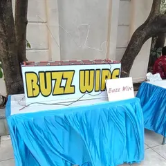 The buzz wire game tests focus and a steady hand. Players must guide a metal loop along a winding wire without touching it and setting off the buzzer.