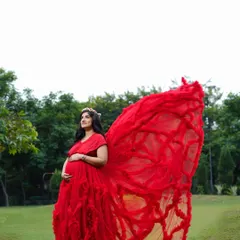 Make a bold statement with this incredible red ruffled gown. Its dramatic design creates a wing-like effect that is simply breathtaking in outdoor settings.