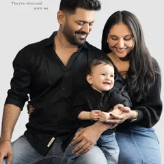 This classic family portrait with a coordinated, casual wardrobe has a relaxed and modern feel. The toddler's infectious smile shows he knows he's the star of the show.