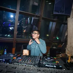 A moment of calm before dropping the next beat. It's all about focus and feeling the rhythm of the room.