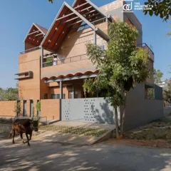 The Madhura house seen from the street, with a local cow wandering past. I design homes to be a part of their context, reflecting the life and rhythm of the neighborhood.