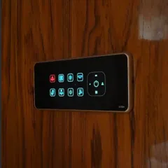 This smart panel is installed on a wooden wardrobe surface, showing how the hardware can be integrated into different materials and designs. The icons are customized for controlling lights, fans, and scenes.