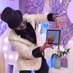 Fusing technology with illusion. Here I am performing a digital magic trick on my iPad, pulling a physical object right out of the screen, much to the amazement of the audience.