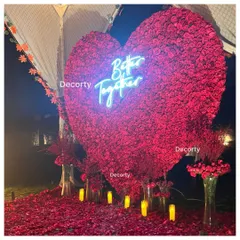 A massive heart-shaped backdrop made entirely of red roses, with a 'Better Together' neon sign. This makes for a stunning photo opportunity and a romantic focal point for any proposal or anniversary.
