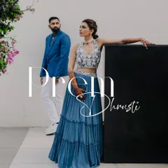 A stylish, editorial-style portrait of a couple at their pre-wedding carnival party.