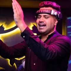 Hyping up the crowd during a VDJ performance. You can see a music video playing on the screen behind me, which is a core element of my Bollyflo sets where I mix audio and video tracks together seamlessly.