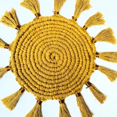 Another look at the intricate spiral weave of the sunburst placemat. This design is not only beautiful but also creates a sturdy, flat surface for your plates or a centerpiece.
