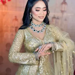 A candid moment showing the soft waves in her hair and the intricate work on her outfit. The makeup is long-lasting to keep you looking fresh all evening.