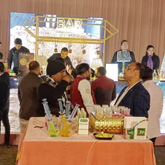 Guests gathering at the bar to try the syringe shots. This setup shows how the shooter station becomes a social hub at the event.