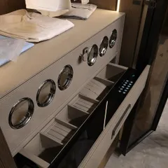 A close-up of a high-tech wardrobe feature: a drawer with a digital lock and specialized compartments. This highlights our ability to integrate modern technology and security into our custom wardrobe designs for ultimate peace of mind.