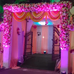 A beautiful floral gate decoration for Ashoka Banquet hall in Vashi. The combination of pink flowers and traditional marigold garlands makes for a classic and festive wedding entrance.