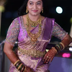 The same lovely bride in a different outfit, a gorgeous purple saree. Her bridal mehendi looks just as beautiful, complementing her reception look perfectly.