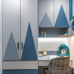 Part of a larger adventure-themed room, this study desk is built into the wardrobe unit to save space. The design includes open shelving for easy access to books and supplies, all within arm's reach.