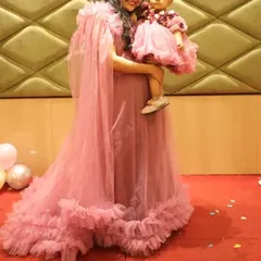 This pink mother-daughter combo features a gown with a detachable cape for mom and a matching frock for the little one. It's available to rent or buy for birthdays.
