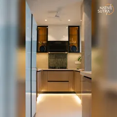 The completed kitchen renovation, showcasing a U-shaped layout that maximizes counter space. We used under-cabinet and floor-level strip lighting to create a bright, welcoming ambiance in this modern kitchen.