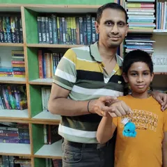 A father and son celebrating a reading achievement together. Our library is a space for families to connect and make lasting memories.