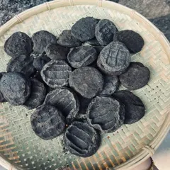 These are Anishi patties, a delicacy of the Ao Naga tribe. Made from sun-dried or smoked Colocasia leaves, they form the base of a unique and earthy black curry.