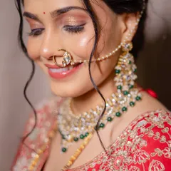 A detailed close-up showcasing the shimmering gold eyeshadow and perfectly blended skin. This soft glam look is ideal for an evening reception, giving the bride a radiant glow.
