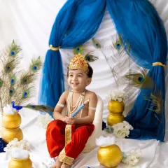 Look at this adorable little Kanha. I have so much fun creating special themed photoshoots for festivals like Janmashtami, complete with costumes and a vibrant setup.