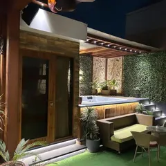 We created this private oasis by integrating a jacuzzi deck seamlessly into the terrace garden. The space features a cozy seating area, lush vertical green walls, and carefully placed lighting to create a tranquil atmosphere for relaxation. An adjoining room provides a space to unwind after a dip.