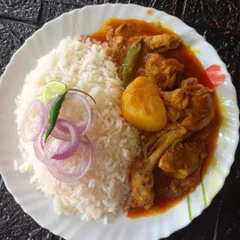 A classic Bengali-style chicken curry with potatoes, served with steamed rice. This dish is slow-cooked with fragrant spices and has a rich, comforting flavor that feels like home.
