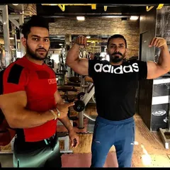 Coaching in action. Here I am with a client, guiding his form and celebrating his progress right on the gym floor.