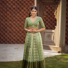A full-length view of this stunning pista green Kanchipuram silk half saree. The checked pattern on the silk and the contrasting dark green border add a layer of classic elegance to this celebratory outfit.