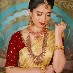 A perfect South Indian bridal portrait. This look features classic temple jewellery, a defined eye with a touch of shimmer, and a bold red lip. The makeup is designed to be picture perfect from every angle.