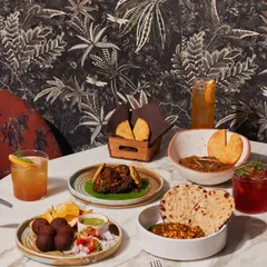 A table full of our signature dishes, from savory small plates to hearty mains. This is what a celebration at Comorin looks like: abundant, flavorful, and perfect for sharing with good company.