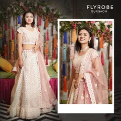 Elevate your style with this exquisite pastel pink lehenga. The delicate embroidery and soft color make it a perfect choice for a day wedding or a sangeet night.