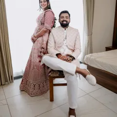 A relaxed indoor portrait of the expecting couple. This simple, modern setup focuses entirely on their happy expressions and connection, showing the versatility of an at home maternity session.