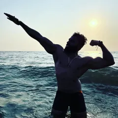 Feeling strong and free in the ocean. This is a moment of pure enjoyment, powered by the discipline and strength forged in the gym.