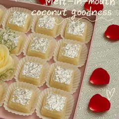 A box of our Nariyal ki Chakki, showcasing its delicate, melt-in-mouth coconut goodness. Each piece is perfectly square and adorned with edible silver leaf, making it a beautiful gift.