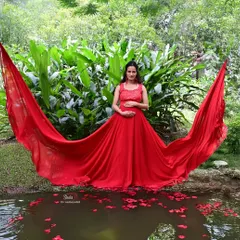 Celebrate your journey to motherhood with a memorable photoshoot. This beautiful red flying gown is designed to be comfortable and stylish, making you feel like a goddess while we capture these precious moments.