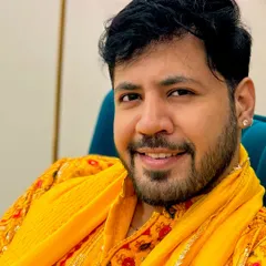 A close-up portrait in a traditional yellow kurta, ready for a day of wedding festivities.
