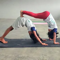Our young swimmers celebrating International Yoga Day with acro yoga. This partner pose, a variation of downward dog, builds strength, trust, and flexibility.