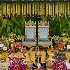 A beautiful, traditional setup for a South Indian ceremony, rich with detail. We combined ornate golden chairs, fresh floral arrangements, brass lamps, and offerings to create a sacred and picturesque space for the couple.