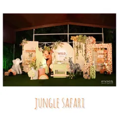 Here is the full view of our pastel jungle safari setup. We combined soft greens and pinks with classic animal prints and props like a friendly zebra and a safari-style dessert cart to create a unique 'Wild One' party.