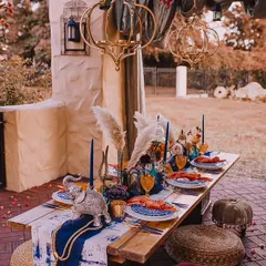 A Moroccan-themed dinner setup for a surprise date or brunch. The rich colors, ornate lanterns, and low seating create an exotic and intimate dining experience.