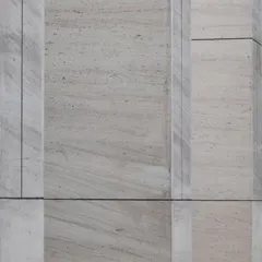 A close-up of the French Beige marble cladding on Stone Boulevard. The image highlights the natural veining of the stone and the precise joinery between panels, showcasing our commitment to material quality and craftsmanship.