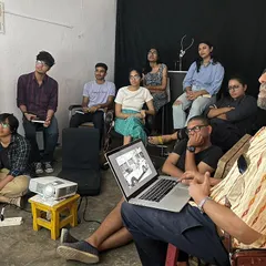 Participants and instructors in a critique session for the OSCH photography project. We foster an environment of open discussion and learning, where artists can share their work and grow together.