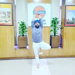 Demonstrating Vrikshasana (Tree Pose) during a corporate wellness camp for Indian Oil. This balancing pose is excellent for improving focus and concentration.