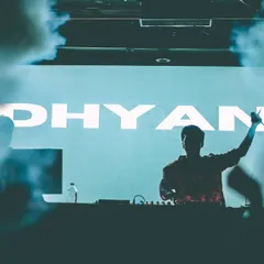 A silhouette shot of me against my name in lights. This image captures the powerful, immersive experience of my club sets, where music and visuals come together.