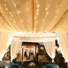 A cozy lounge area with deep green velvet sofas, perfect for guests to relax.