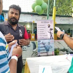 Explaining the key points of self-defense to parents and visitors at our event booth. Awareness is the first and most important step.
