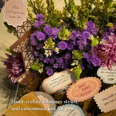 A Paris-themed hamper designed for a true romantic. It features a stunning floral arrangement, an Eiffel Tower cutout, and personalized tags with sweet messages, showing how I can bring any theme to life.